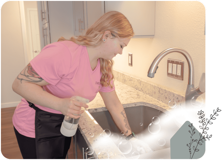 A CHRIStal Clean team member cleaning a kitchen sink